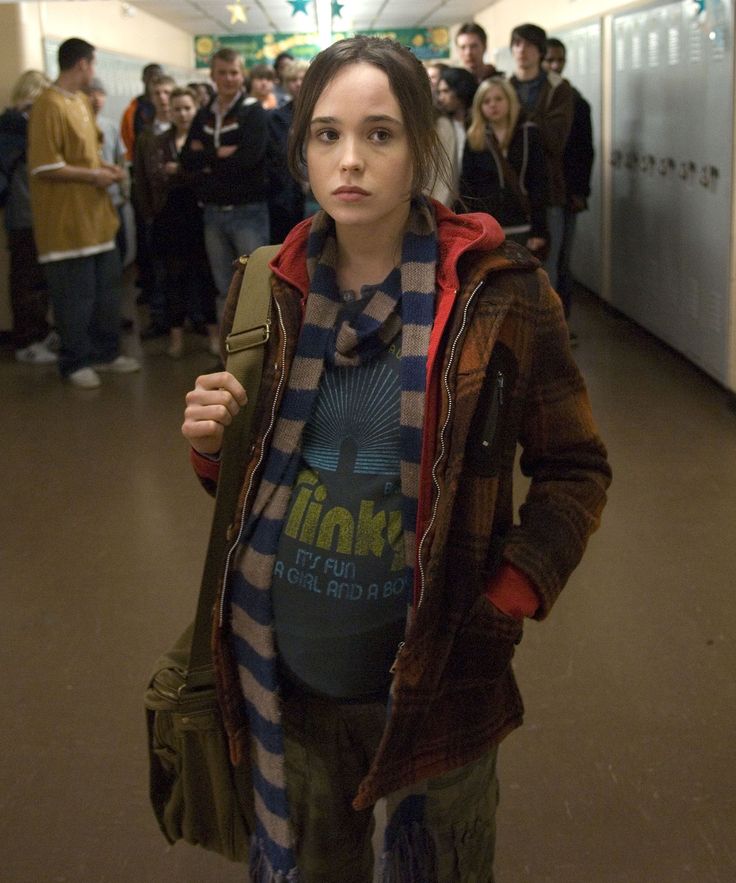 a young woman standing in front of a group of people