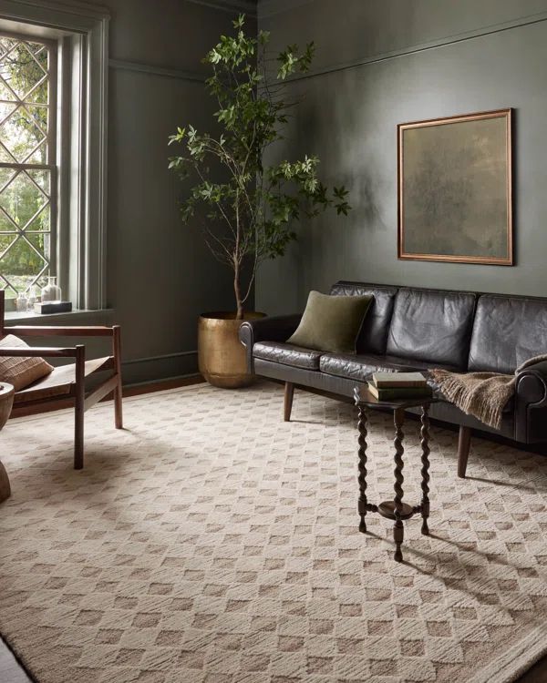 a living room filled with furniture and a potted plant on top of a table