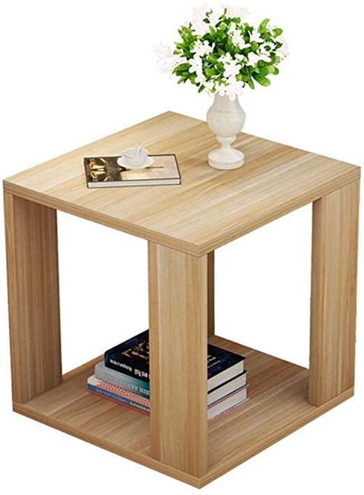 a small wooden table with books and a vase on top