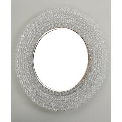 a round mirror with beads around it