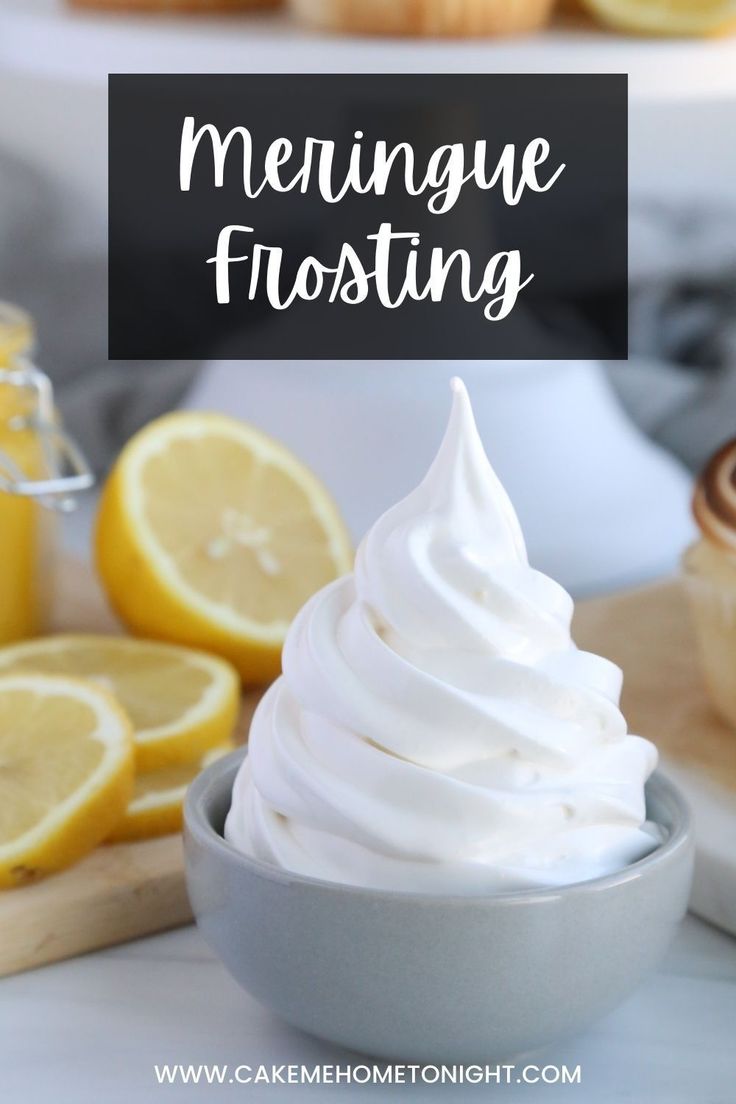 lemon meringue frosting in a bowl next to sliced lemons