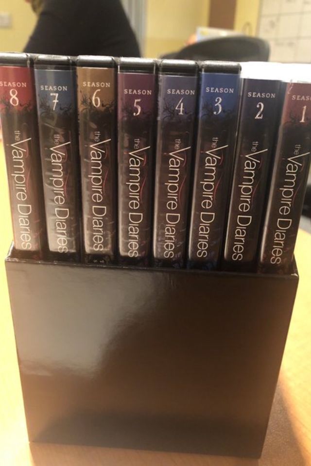 a stack of books sitting on top of a wooden table