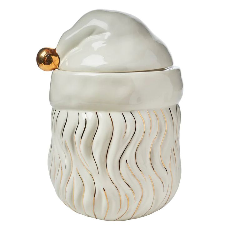 a white ceramic cookie jar with a gold top and wavy design on the lid,