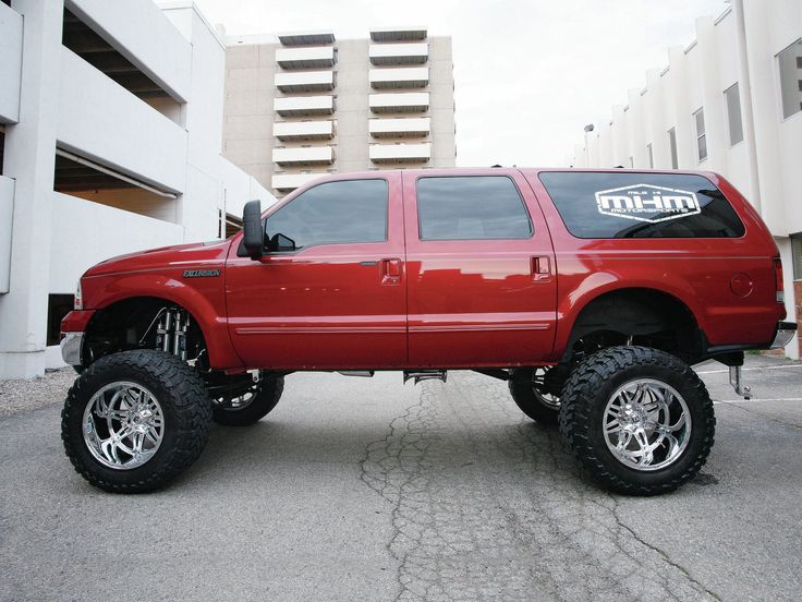 a red pick up truck parked in a parking lot