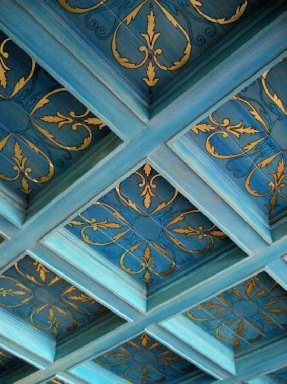 the blue ceiling has gold designs on it