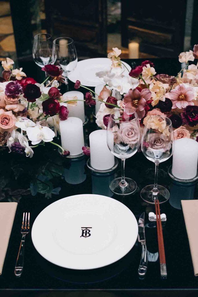 the table is set with flowers and candles