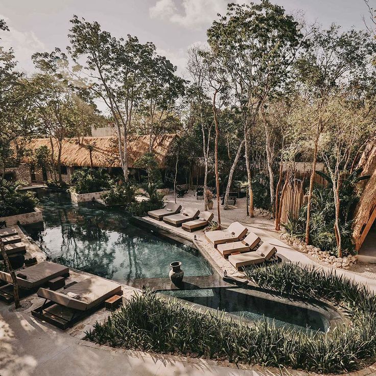 an outdoor swimming pool surrounded by trees