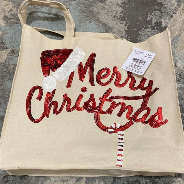 a white bag with red sequins and santa's hat on it that says merry christmas