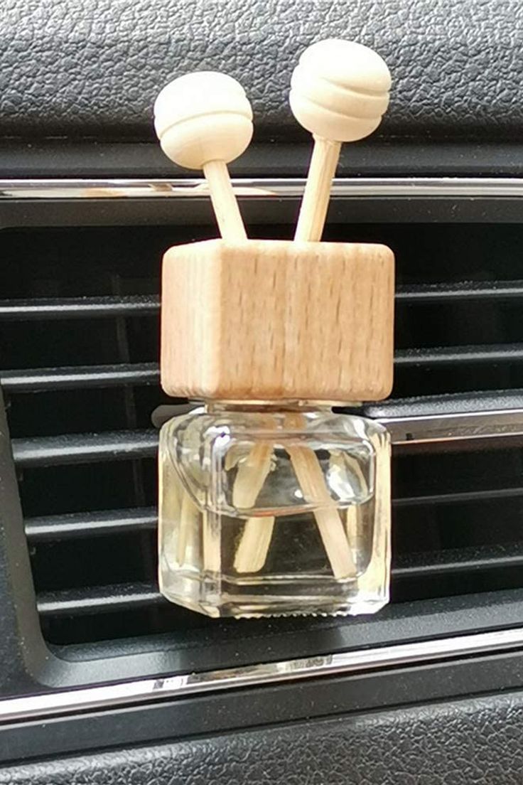 two wooden sticks sticking out of the air vent in a car's dash board