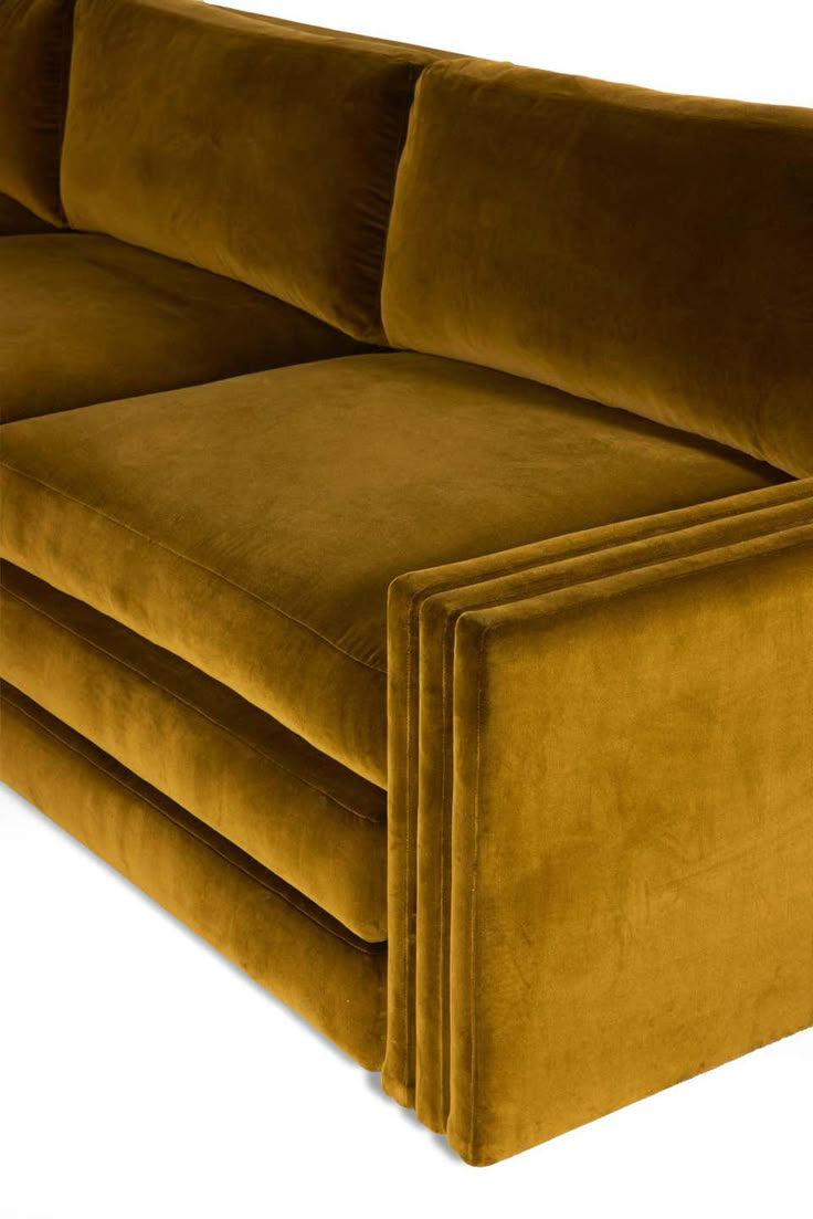 a brown couch sitting on top of a white floor