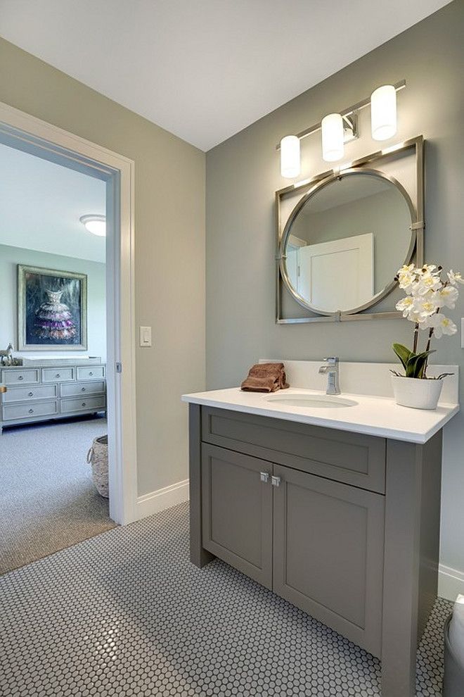 a bathroom with a sink, mirror and toilet in it's center piece is shown