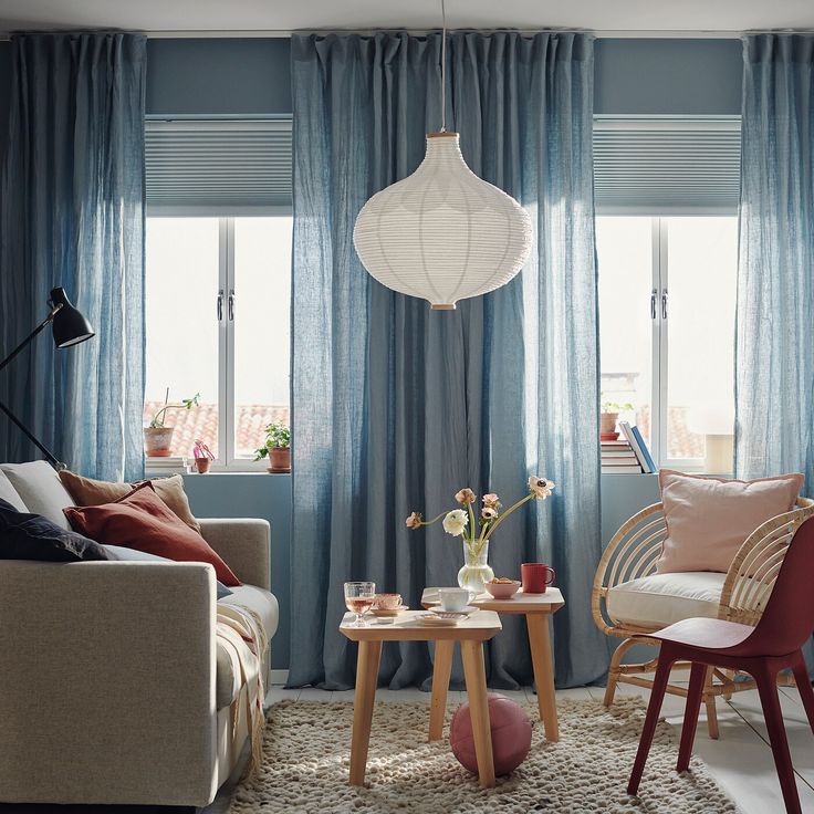 a living room filled with furniture and curtains