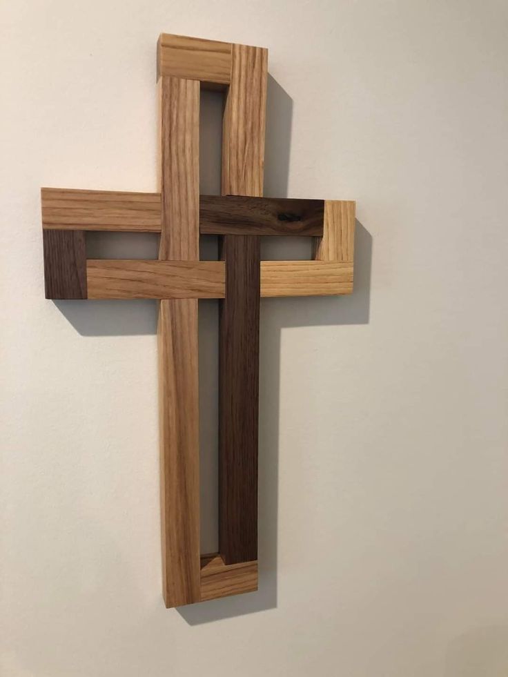 a wooden cross hanging on the wall