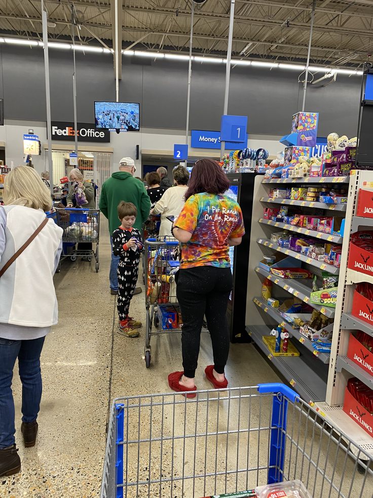 people shopping in a grocery store with carts