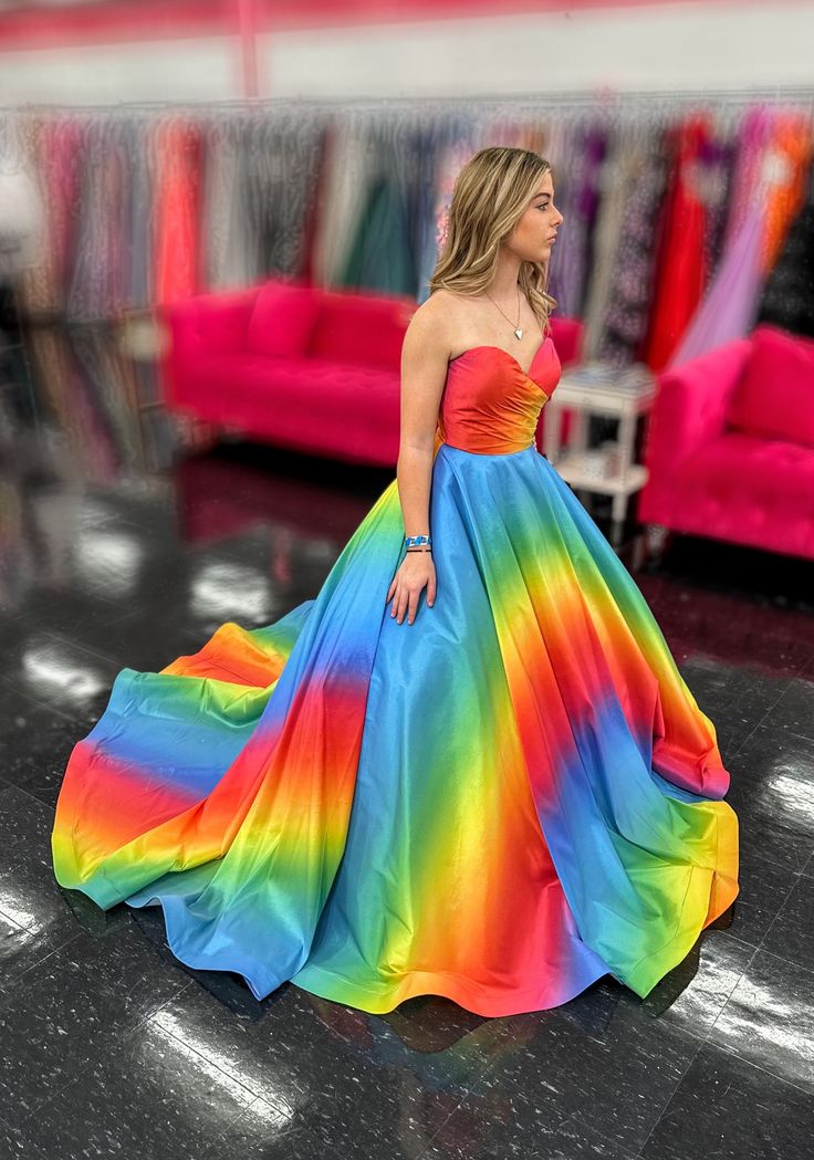 Be the center of attention in this eye-catching Johnathan Kayne 2202 Rainbow Dress. The strapless ombre formal gown features a stunning cut out back with bow details, making you stand out from the crowd. With a super full and unique skirt, this one-of-a-kind dress will make you feel truly special. Size: 4 Color: Rainbow Strapless Multicolor Dress For Gala, Multicolor Strapless Dress For Gala, Strapless Ball Gown For Prom Season Homecoming, Multicolor Floor-length Gown With Fitted Bodice, Multicolor Evening Gown With Fitted Bodice, Multicolor Gown With Fitted Bodice For Evening, Formal Fitted Ombre Dress, Multicolor Fitted Gown For Gala, Multicolor Fitted Gala Gown