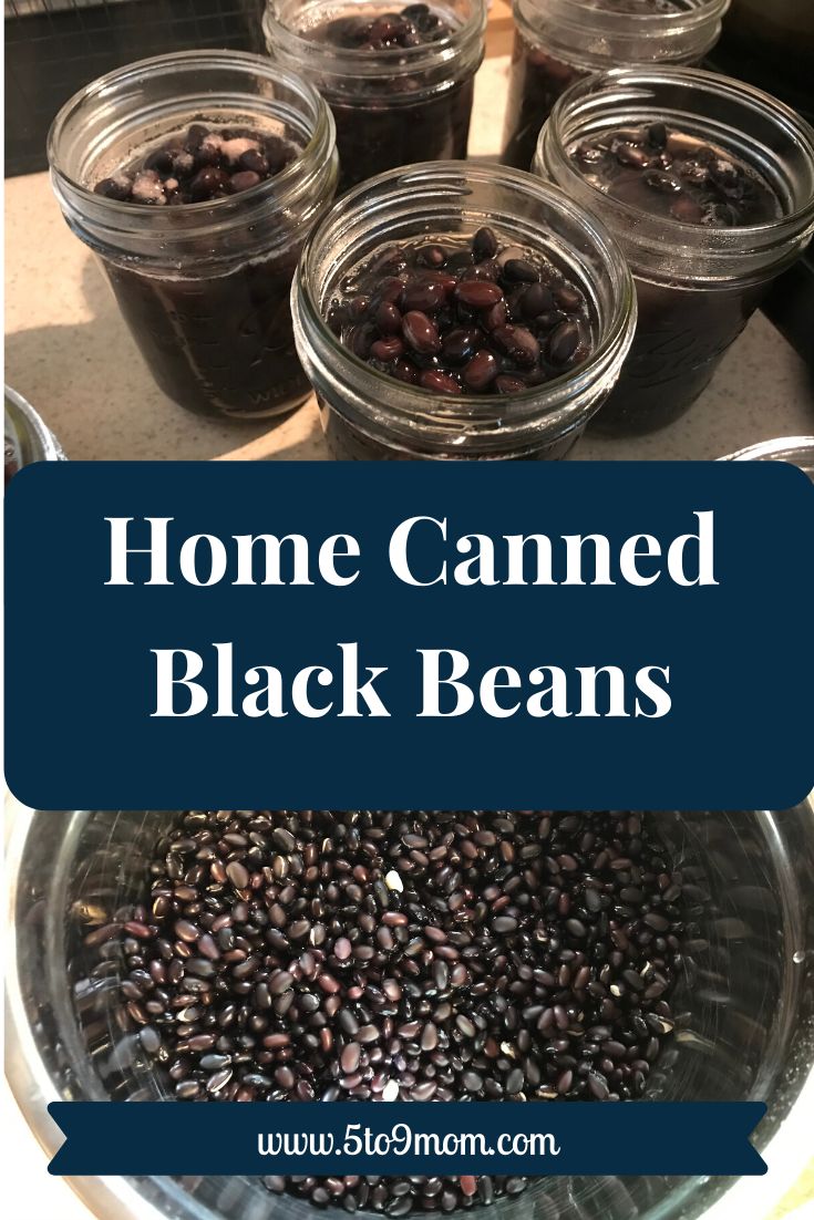 jars filled with black beans sitting on top of a table