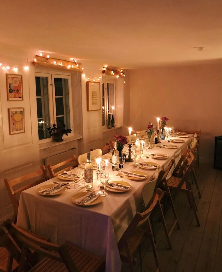 a long table is set with candles and plates