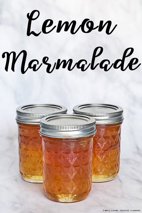 three jars filled with lemon marmalade sitting on top of a white marble counter