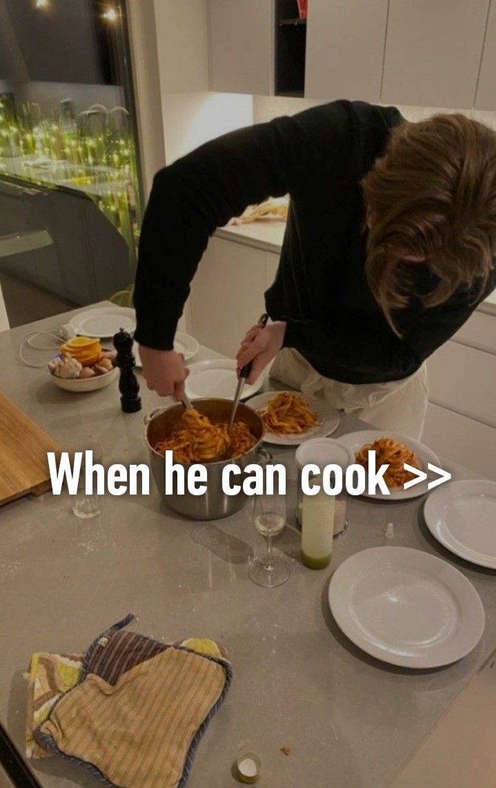 a woman standing over a table filled with plates and bowls full of food while holding a knife