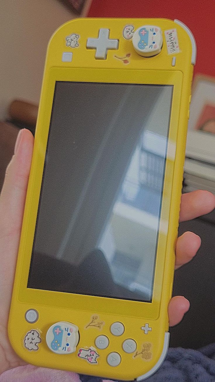 a person holding up a yellow children's tablet