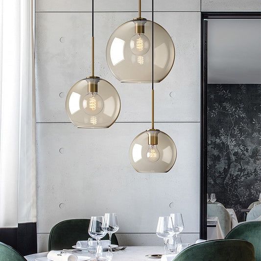 an elegant dining room with green chairs and white tablecloths, hanging lights over the tables