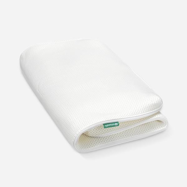 an image of a white travel pillow on a white background with the cover folded up