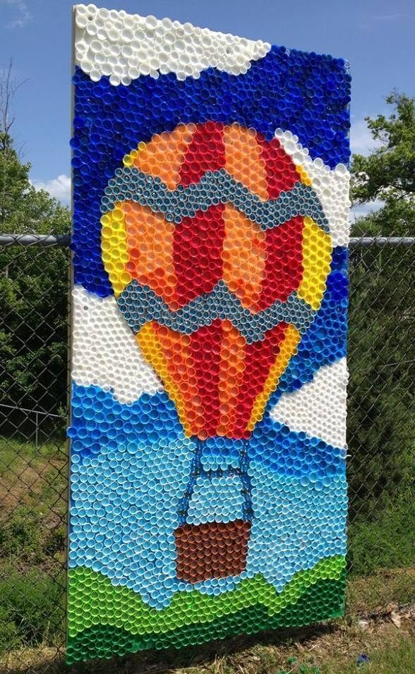 a large piece of art made out of plastic bottle caps and other items in the shape of a hot air balloon