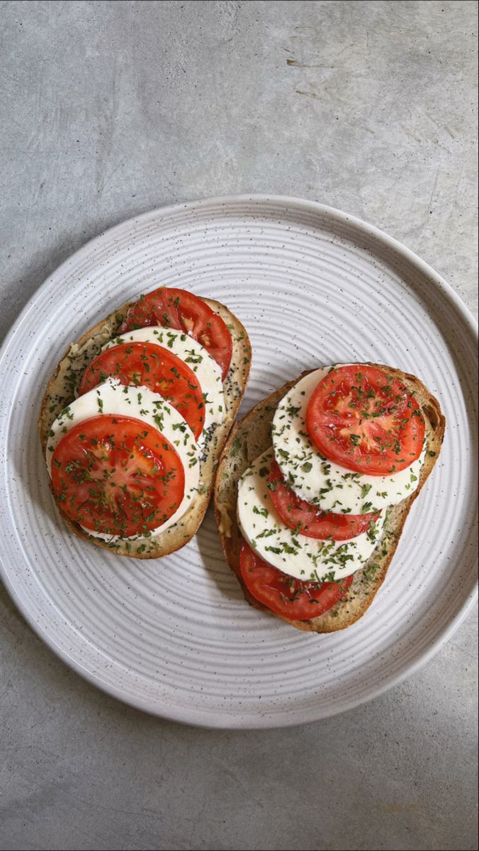 two slices of bread topped with tomatoes and cheese