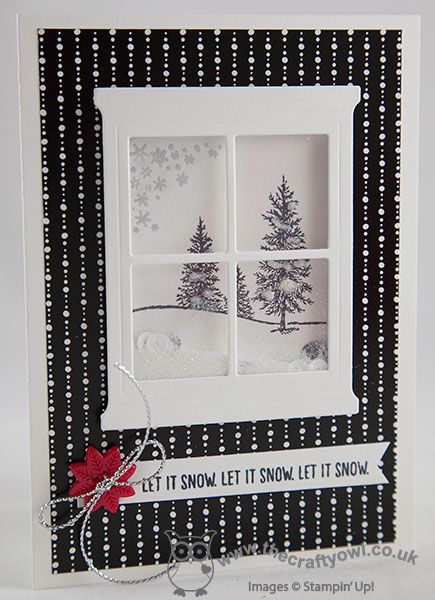 a card with a window that says let it snow and has a red bow on the front