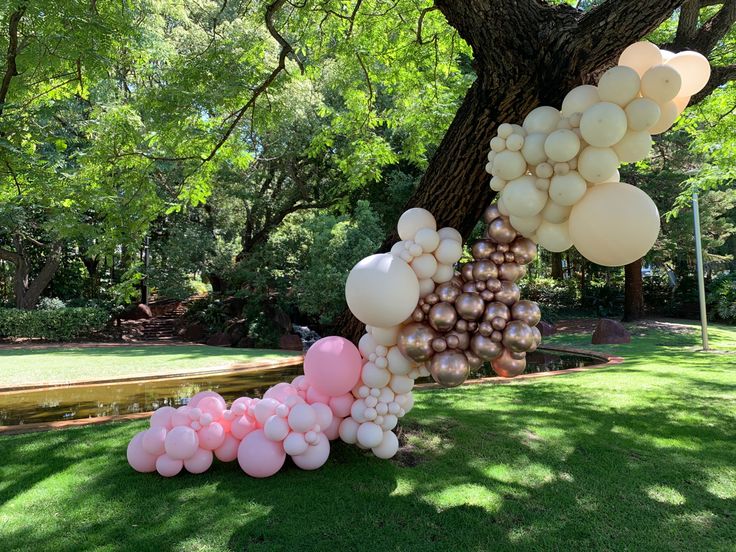 a bunch of balloons hanging from a tree