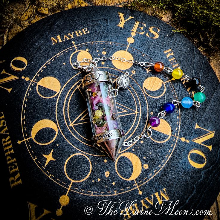 a pen with seven chakras on it sitting on top of a clock face