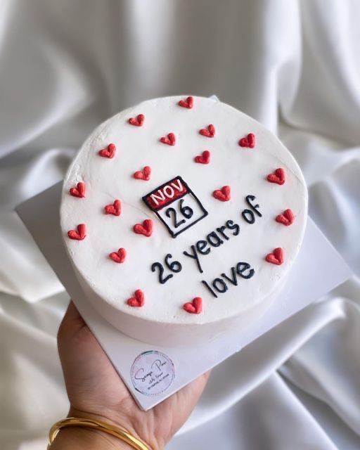 a white cake with red hearts and the number twenty two years of love on it