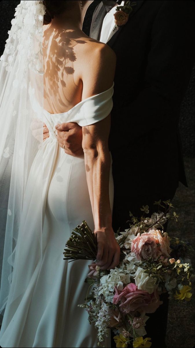 the bride and groom are posing for a photo