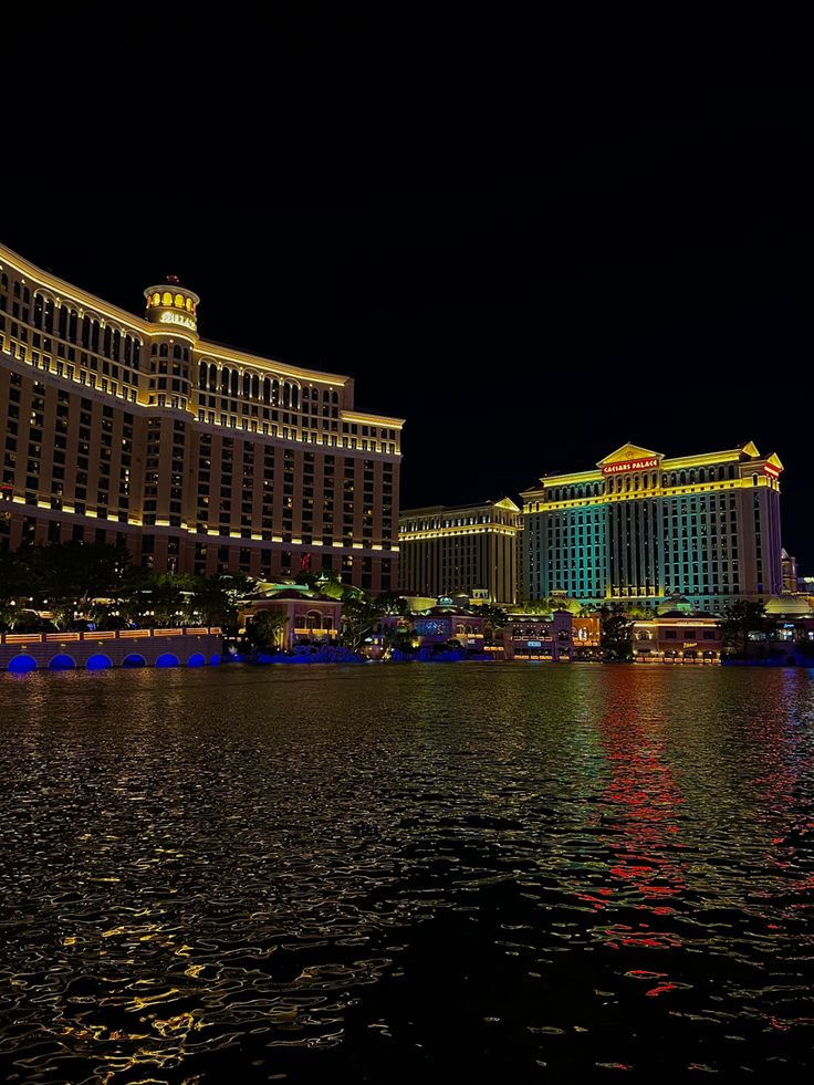 the las vegas hotel and casino are lit up in blue, green, yellow and red