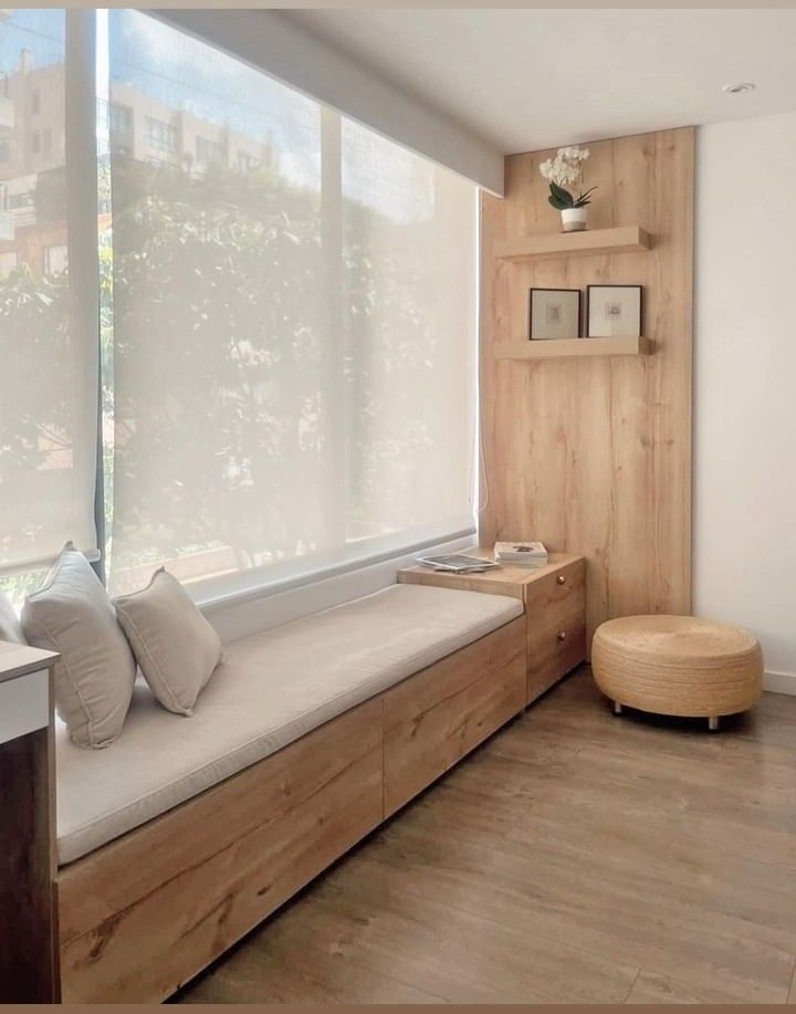 a window seat with pillows on it in a room