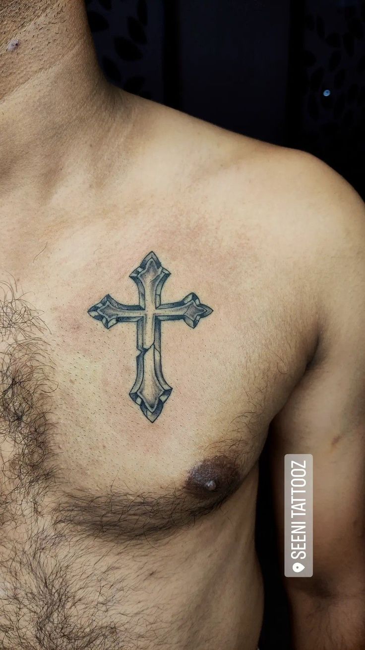 a man with a cross tattoo on his chest