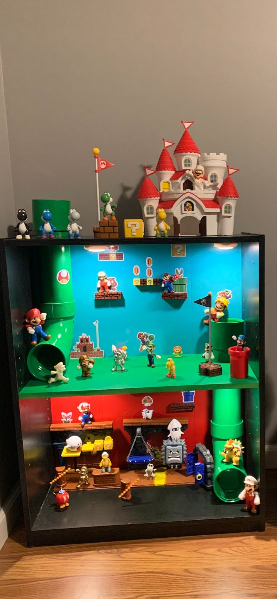 a display case filled with legos on top of a wooden floor next to a wall