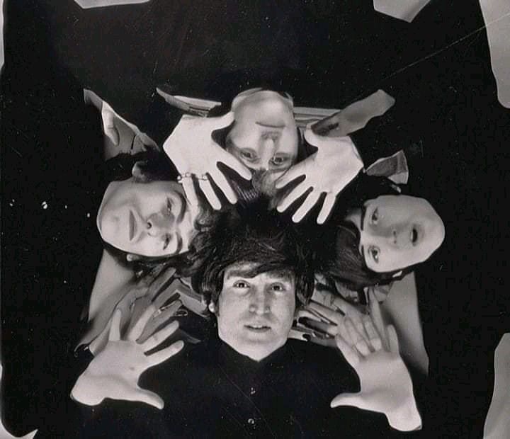 a group of people standing in a circle with their hands on top of each other