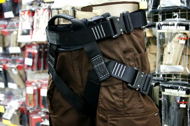 the back of a man's pants with straps on display in a store aisle