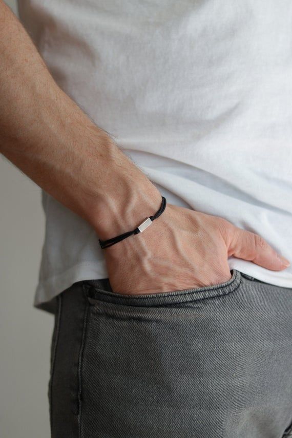 Bracelet for men - cord bracelet with a silver plated rectangle bead charm. The color of the cord in the picture is black and it is made of waxed cotton. The charm is silver plated. Clasp closure. You can request a different cord color from the colors shown in the last picture.The bracelet is 7 1/2 inches long (19 cm). If you would like a different length please choose your option at checkout.This bracelet is great as a gift for a man or a boy. All of our jewelry comes wrapped and ready for gift Minimalist Jewelry For Men, Men Minimal Jewelry, Men Bracelet Black, Black Mens Bracelet, Men Hand Jewelry, Male Jewelry Aesthetic, Men’s Bracelet, Bracelet Ideas For Men, Men’s Jewelry