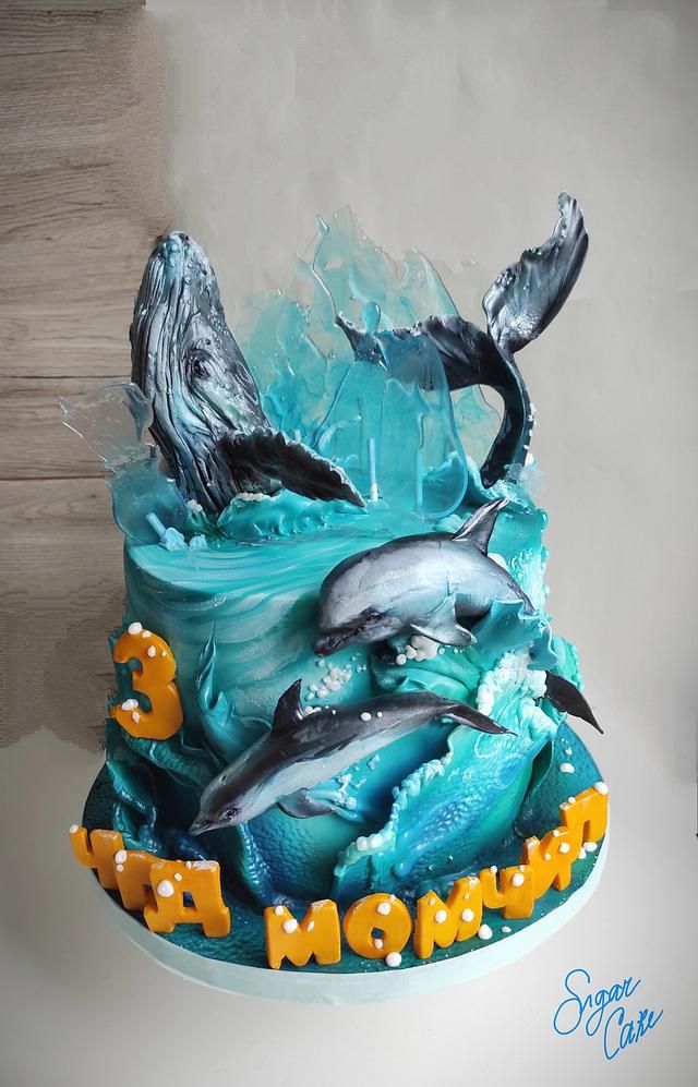 there is a cake with dolphins on it