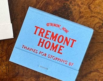 there is a blue box that says tremontt home thanks for stopping by on the table