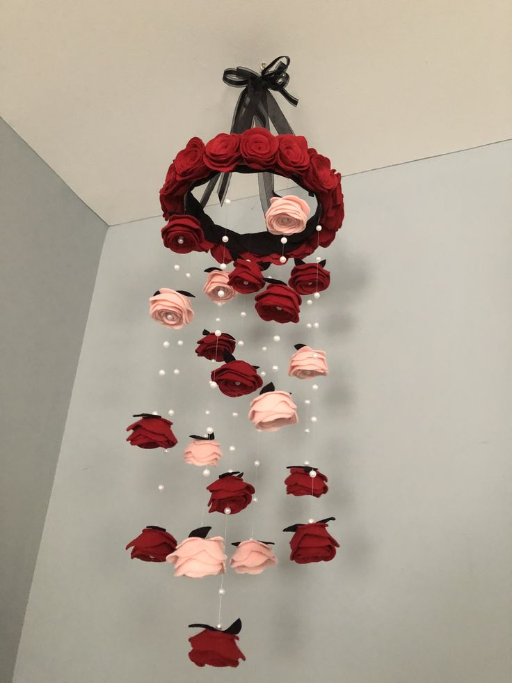 a red rose wreath hanging from the ceiling