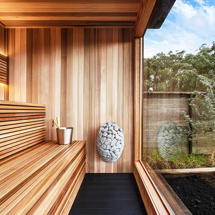 a large vase sitting on top of a wooden shelf next to a window filled with water