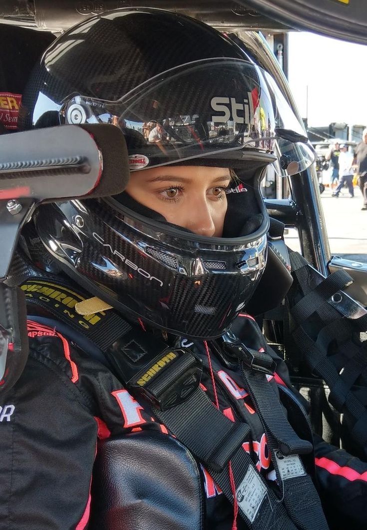 a person wearing a helmet sitting in a car