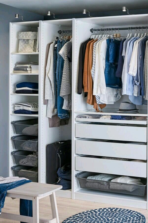 an organized closet with clothes and other items