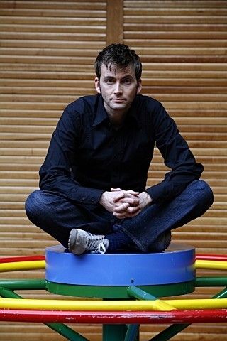 a man sitting on top of a colorful object