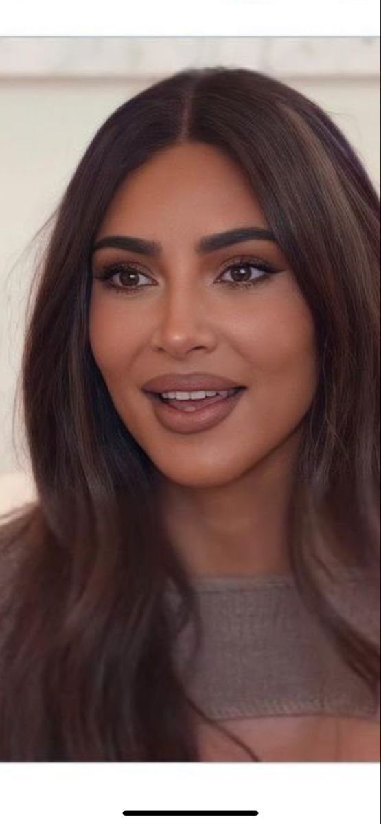 an image of a woman with long hair and brown eyeshadow, looking at the camera