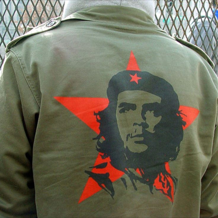 a man wearing a green jacket with a red star and che gue on it