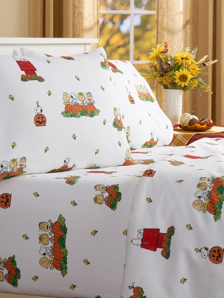 a bed with peanuts and pumpkins on it